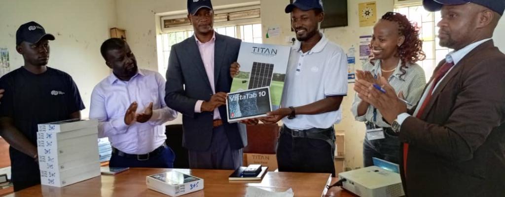 The Deputy RDC, dressed in a blue suit, received 50 tablets to support PDM activities on behalf of the district from the Ministry of ICT and National Guidance representative. The handover took place in the presence of officials from the Ministry of Finance, Planning and Economic Development, UCC, the CAO's representative, and the Senior IT Officer for Ntoroko District Local Government.
Distribution of Tablets to Support PDM